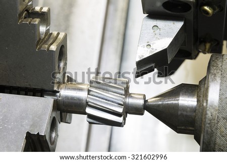 Operator machining automotive gear by cnc turning machine
