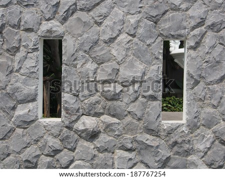Stone wall with 2 square windows for sneak-a-peak.