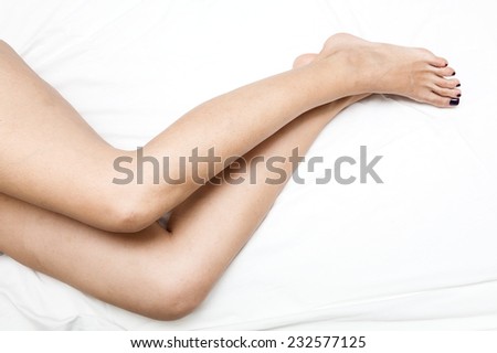 Shaved and smooth woman\'s long legs. Isolated on white with