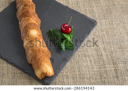 Cookies and cakes with fruit on slate plate