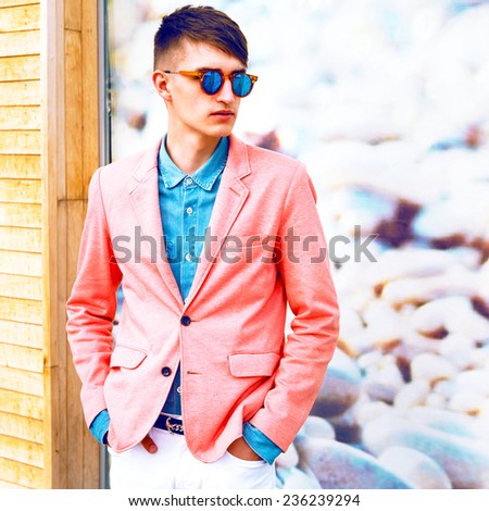 Fashion image of young stylish handsome hipster guy, wearing trendy suit and sunglasses.