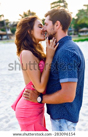 Young couple in love. Closeup colorful stylish sensual portrait of young beautiful couple in love kissing and happy together, summer luxury style.