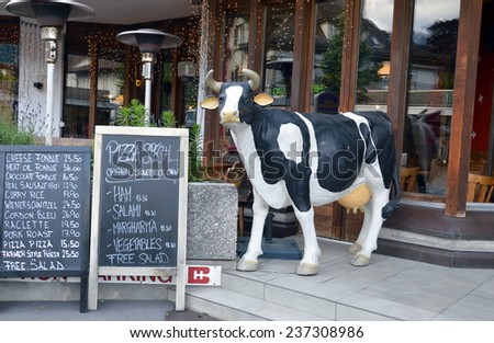 Interlaken, Switzerland- June 2,2014  milk cow in front of restaurant at Interlaken Switzerland