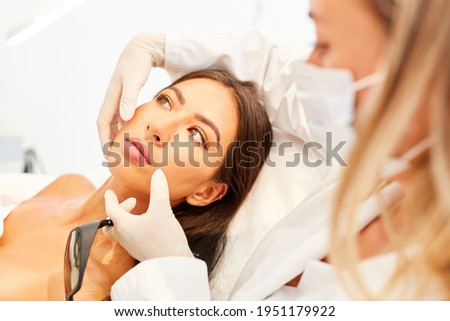 Doctor advising patient about a facelift in the beauty clinic