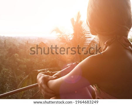 Woman enjoying panoramic landscape view on a rainforest in Bali, Indonesia.	
