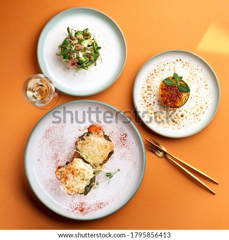 Florentine eggs - poached eggs and a delicious avocado salad, dessert cr me brulee in orange background Photo stock © 