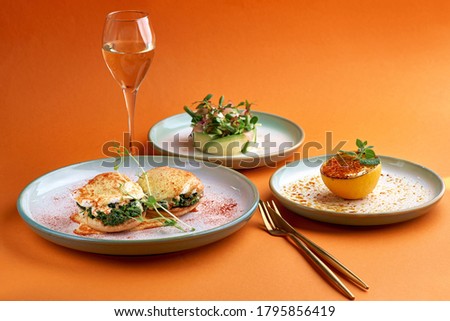 Florentine eggs poached eggs and a delicious avocado salad, dessert cr me brulee in orange background Photo stock © 
