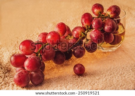 ripe grapes and grape juice in a glass