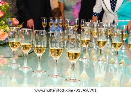 set standing on a table with glasses of champagne
