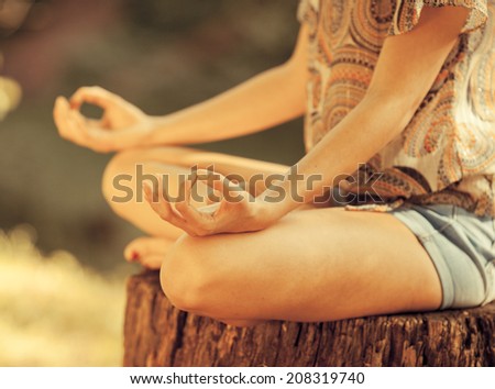 Young female meditate in nature.Close-up image.