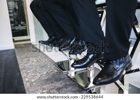 Three men in a black shoes