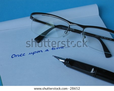 A fountain pen on written paper with glasses.