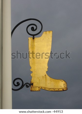 Golden metal boot-shaped company label.