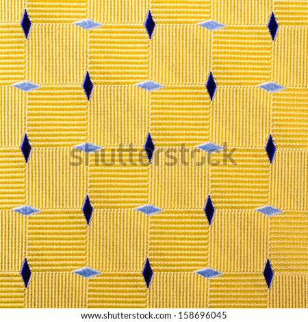 Abstract yellow cloth background with blue diamond shapes