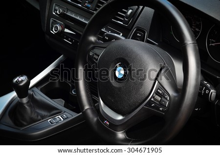 LONDON - AUGUST 10: BMW passenger car interior showing steering wheel and gear shift. August 10, 2015 in London, UK.