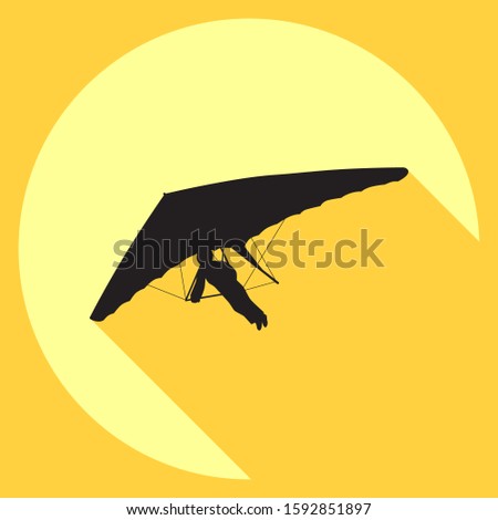 Hang glider icon. Vector drawing of a black silhouette of a hang glider on a background of yellow sun.
