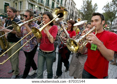 BARCELONA - SEPT, 24: Musicians of music troop Les Ouiche Lorenea in full swing perform at Las Ramblas during a Festival City on September 24, 2004 in Barcelona, Spain