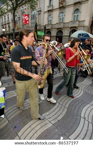 BARCELONA - SEPT 24: Musicians of music troop Les Ouiche Lorenea in full swing perform at Las Ramblas during a Festival City on September 24, 2004 in Barcelona, Spain
