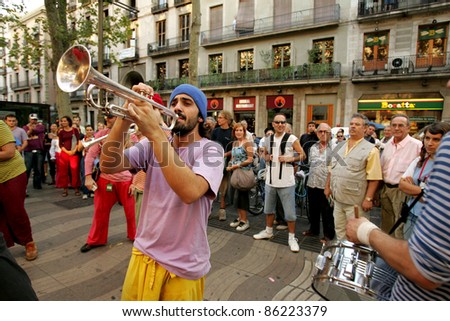 BARCELONA - SEPT, 24: Trumpeter of music troop in full swing performing his show at Las Ramblas during a Festival City on September 24, 2004 in Barcelona, Spain