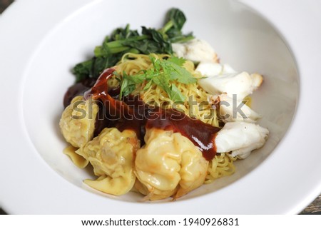Shrimp dumpling noodles and crab meat on wood background
