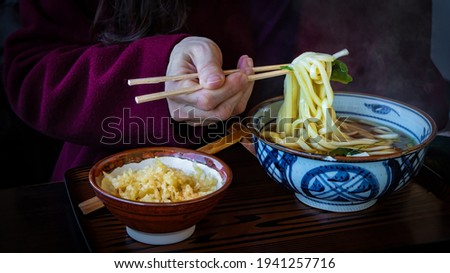 Chopsticks and steamy bowl of ramen at the dinner table in Hakone,  Japan.