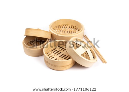 Asian or Chinese bamboo vegetable and dumpling steamers isolated on white