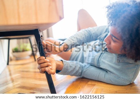 Similar – Image, Stock Photo Afro woman repairing furniture at home.