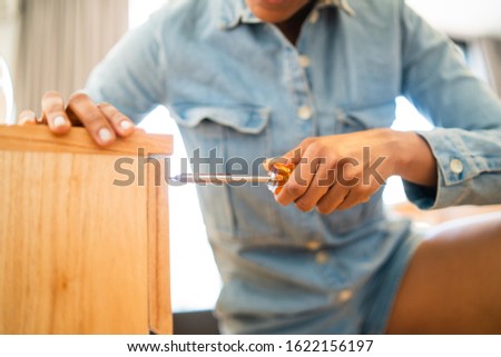 Similar – Image, Stock Photo Afro woman repairing furniture at home.