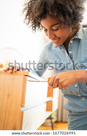 Similar – Image, Stock Photo Afro woman repairing furniture at home.