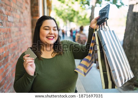 Young woman doing shopping with credit card.