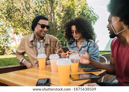 Afro friends having fun together while drinking fruit juice.