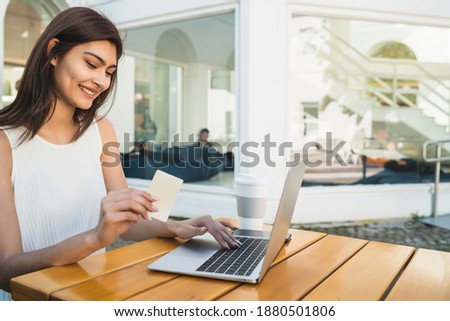 Young woman using laptop to shop online.