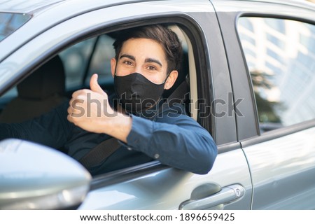 Young man driving his car.