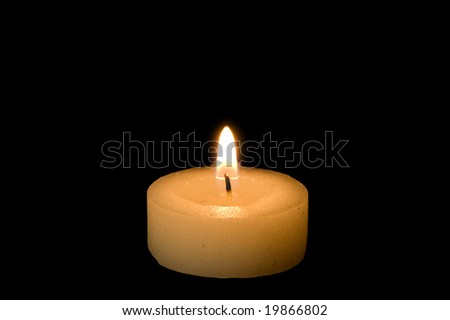 Little candle isolated on black background