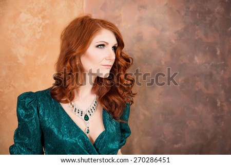 Elegant woman in retro style sitting at the table. Green dress