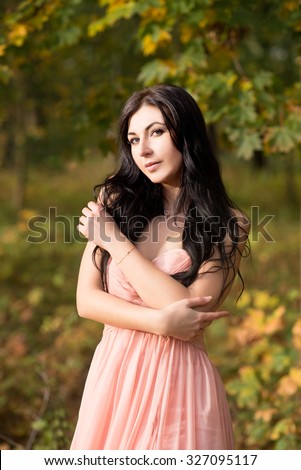 Attractive sensual woman in pink dress. Autumn, fall