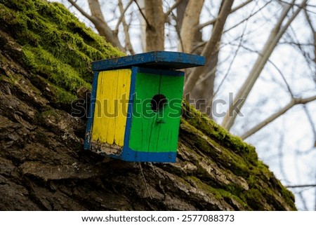 Similar – Foto Bild Am Baum hängendes Vogelhaus mit dem kreisförmigen Eingangsloch