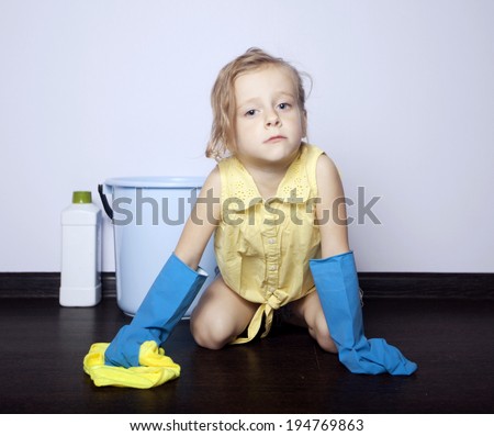 little girl washes the floor