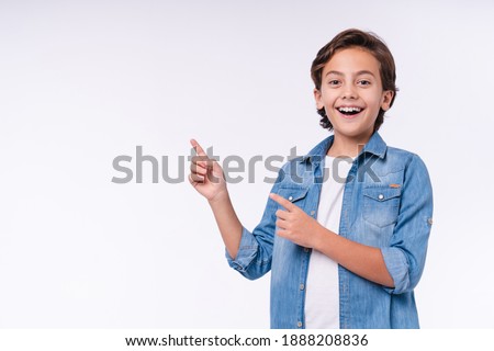 Similar – Image, Stock Photo friendly boy stands on a meadow and looks for floating autumn leaves