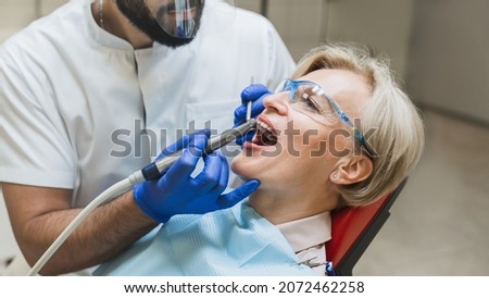 Male orthodontist checkup. Perfect ideal healthy smile. Stomatological dental equipment, dentist whitening filling tooth teeth of female patient at dental hospital Foto stock © 