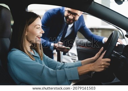 Similar – Image, Stock Photo Woman sitting on driver seat and putting on gloves