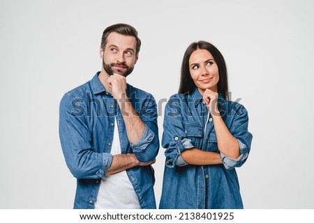 Contemplation of two lovers caucasian young couple spouses wife and husband boyfriend and girlfriend looking upwards, planning for future, thoughtful and pensive people isolated in white Foto stock © 