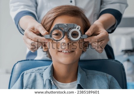 Similar – Image, Stock Photo child wearing glasses and writing while being really concentrated