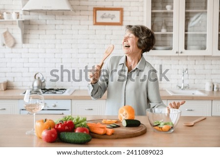 Similar – Image, Stock Photo Elderly woman is cutting branches, pruning fruit trees with shears