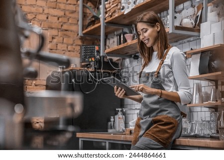 Image, Stock Photo Cheerful businesswoman browsing tablet in office