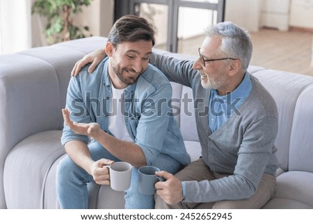 Similar – Image, Stock Photo Grandfather talking to his grandchildren and relatives, who were quarantined from home, about the coronavirus. Elderly man using smartphone and tablet in his office