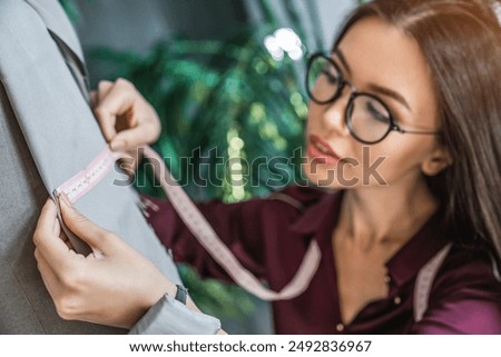 Similar – Image, Stock Photo Female tailor drawing cutout in workshop