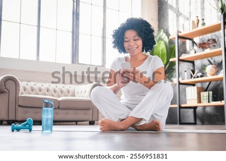 Similar – Image, Stock Photo Content sportswoman with water bottle taking selfie on smartphone