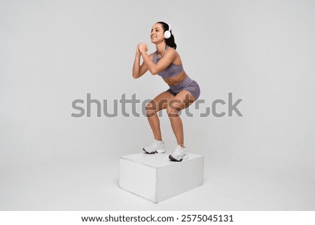 Similar – Image, Stock Photo Focused sportswoman doing squats with elastic band in apartment