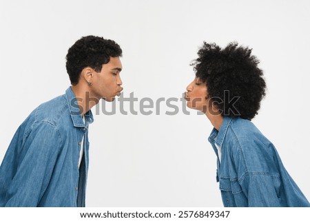 Similar – Image, Stock Photo Young ethnic man kissing cheek of smiling girlfriend working remotely on netbook in cafeteria